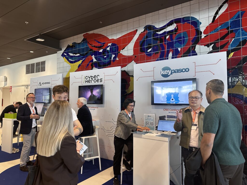 Keypasco team speaking with visitors at the ONE Conference 2026 exhibition stand