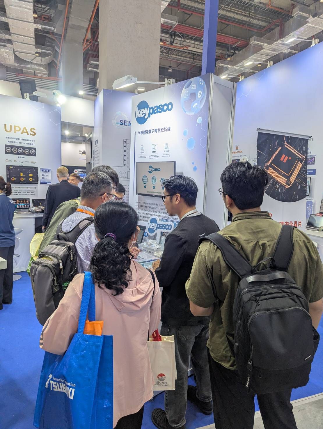 Visitors discuss identity security at the Keypasco display area at SEMICON Taiwan 2026